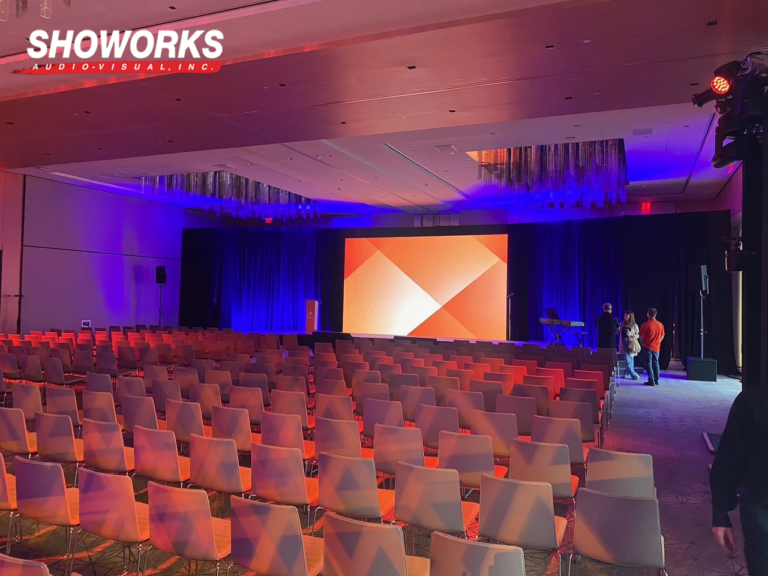 The Evolution of Event Staging: From Traditional to Innovative Designs 1 Contemporary event stage with LED wall, colorful lighting, and rows of seating designed by Showorks Audio-Visual, Inc.