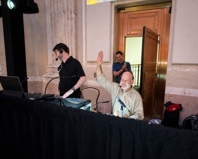 Live event production team collaborating backstage during an event, demonstrating strong event production company partnerships and teamwork.
