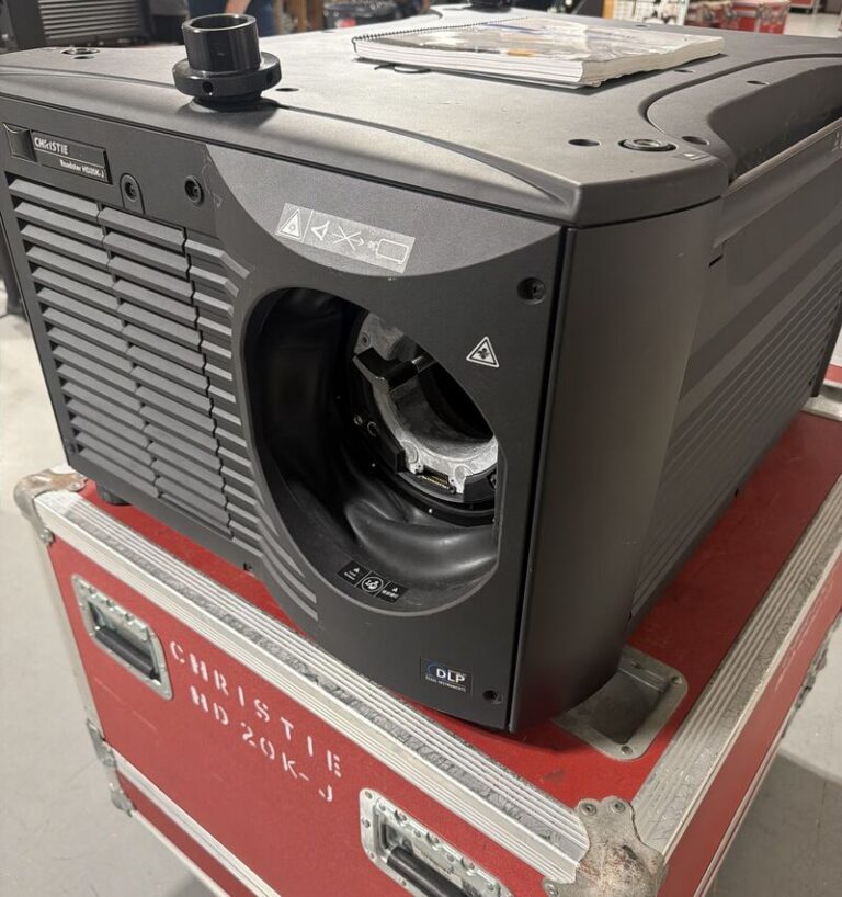 A Projector in a warehouse, highlighting the evolution of audio visual production technology and equipment investments.