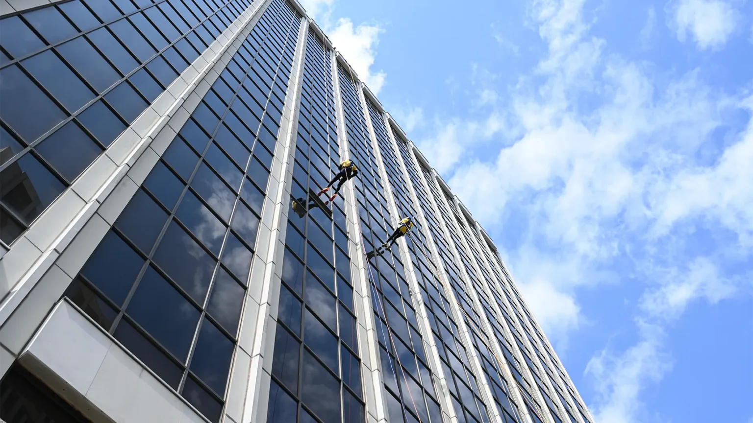 Participants rappel down 300 Delaware Avenue during the Over the Edge 2026 fundraiser supported by Showorks with AV production and livestream coverage.